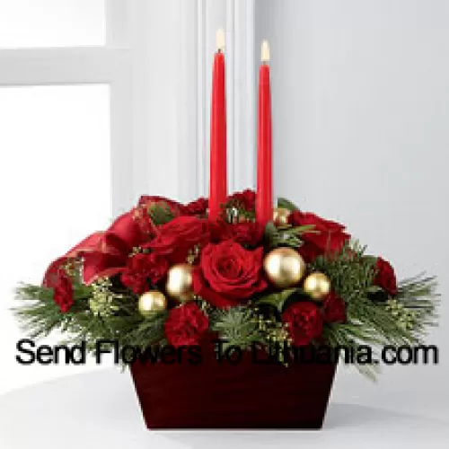 An exquisite display of holiday beauty to add warmth and cheer to their special celebrations. Rich red roses and burgundy mini carnations are set to impress surrounded by lush holiday greens, seeded eucalyptus, gold glass balls and a gold-edged red ribbon arranged elegantly around two red taper candles. Presented in a chocolate brown bamboo container, this centerpiece will usher in joy and goodwill with each treasured bloom (Please Note That We Reserve The Right To Substitute Any Product With A Suitable Product Of Equal Value In Case Of Non-Availability Of A Certain Product)